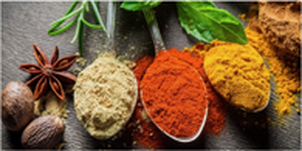 Herbs and spices arranged on a dark table